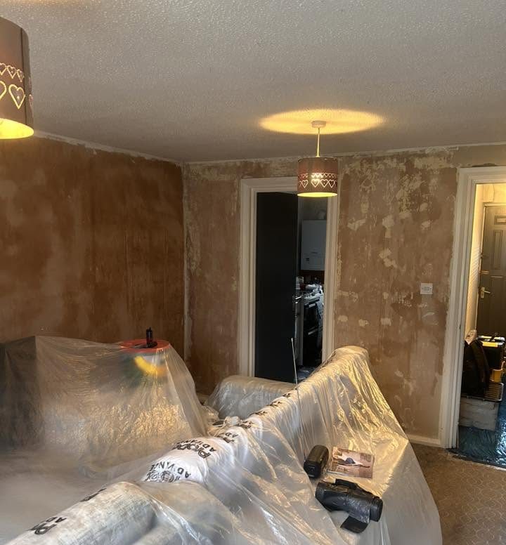 Livingroom wall stripped off wallpaper and prepped for painting