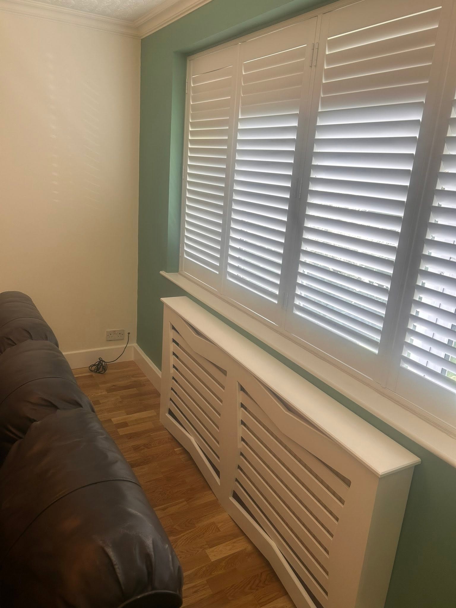 Large window wall painted a bright green shade